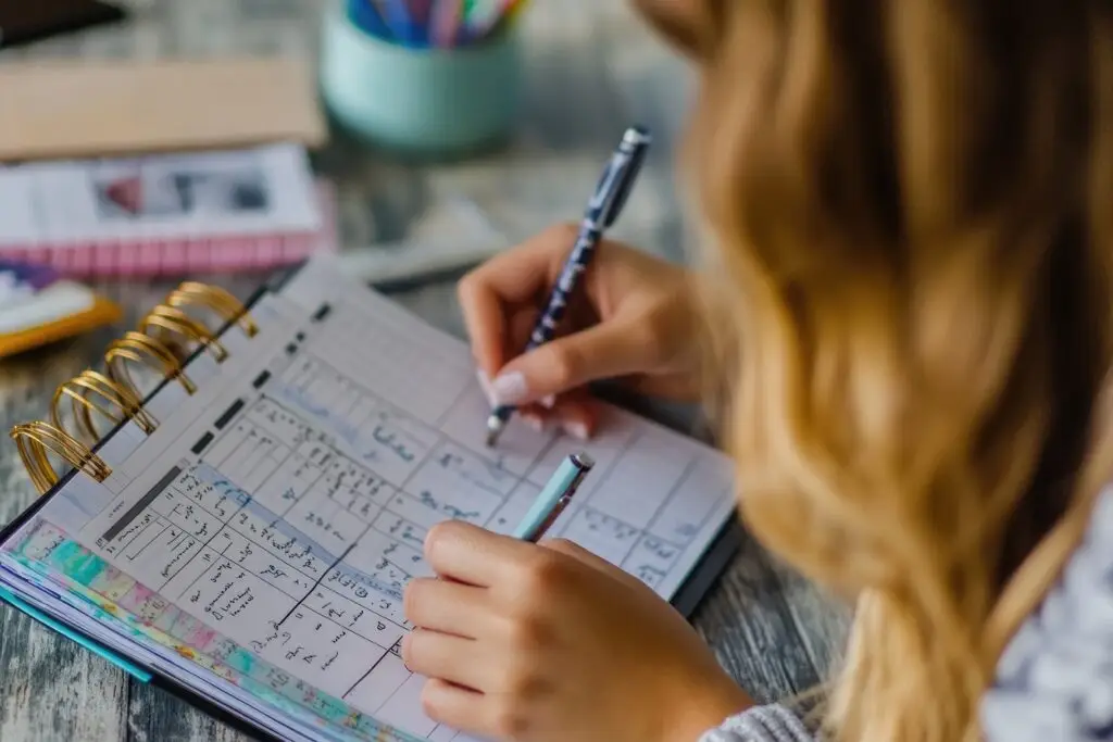 someone making notes in a planner, getting organized and ready
